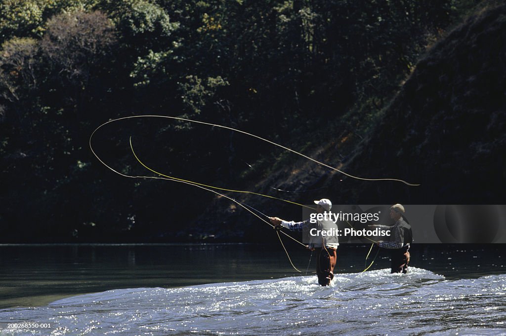 Two men fly fishing on lake