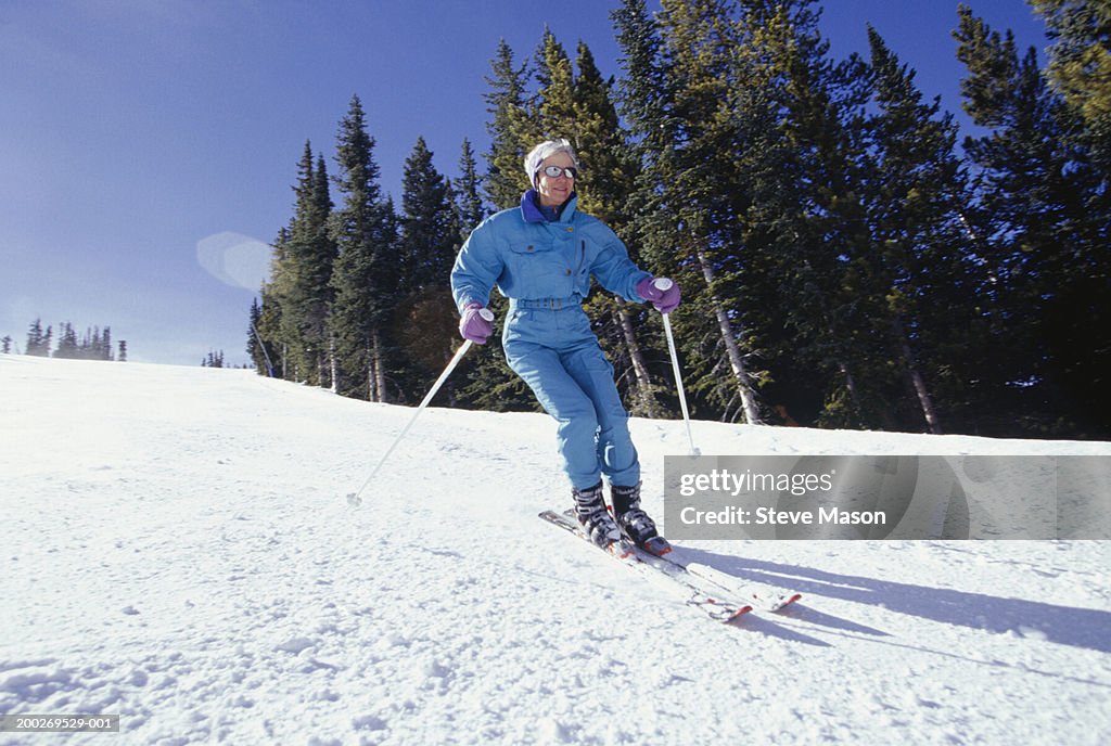 Woman skiing down slope