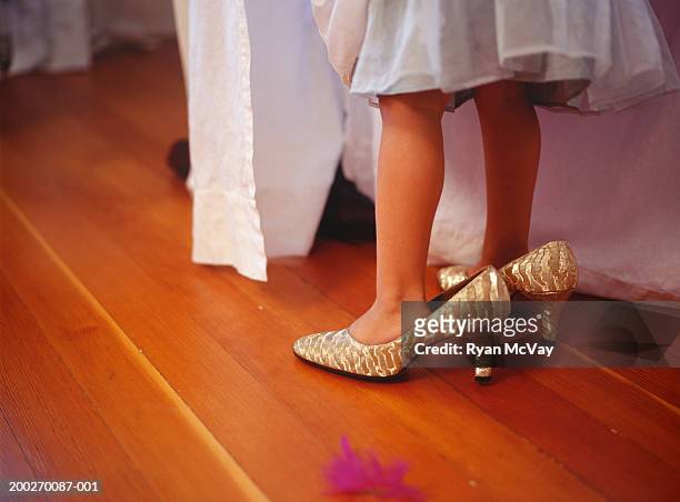 girl (4-5) wearing oversize high heels, close-up of feet - kid in big shoes stock pictures, royalty-free photos & images