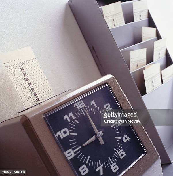 time clock marking time card, close-up - time clock stock pictures, royalty-free photos & images