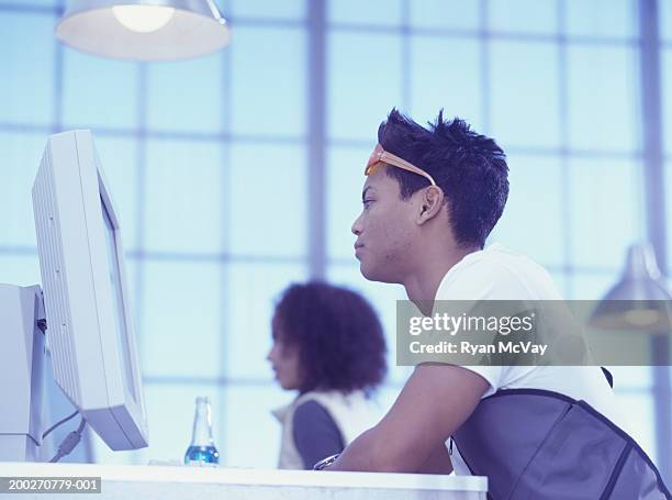 people using computers at internet cafe, low angle view - casual low view desk cafe stockfoto's en -beelden