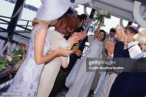 guests applauding bride and groom at wedding reception - jewish wedding ceremony stock pictures, royalty-free photos & images