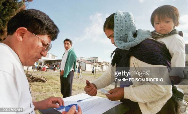An indigenous woman registers to vote with her fingerprint in Calderon, Ecuador, on the outskirts of Quito 12 July. Ecuador is holding presidential...