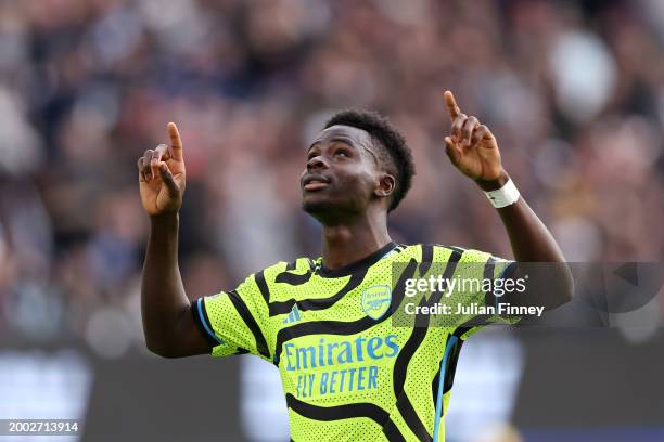 Bukayo Saka of Arsenal celebrates scoring his team's second goal from the penalty spot during the Premier League match between West Ham United and...