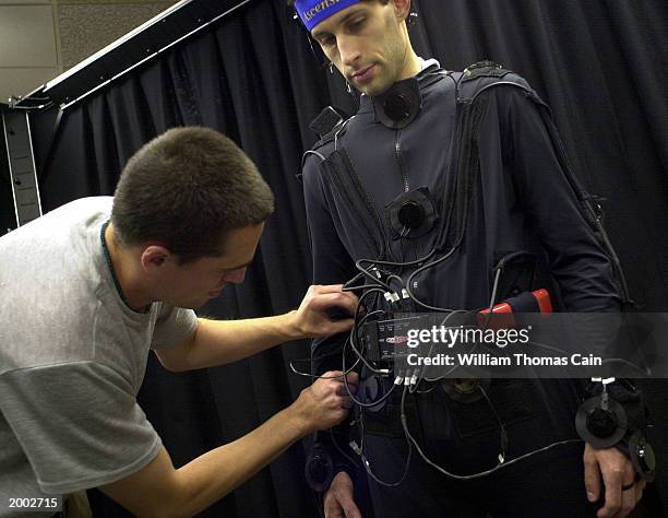 University of Pennsylvania student Aaron Bloomfield is connected to sensors by fellow student Durell Bouchard as they prepare to demonstrate the...