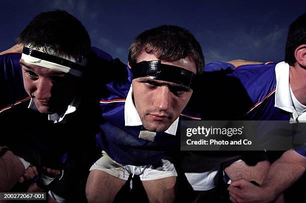 front row of rugby team preparing for scrummage, close-up - scrum stock pictures, royalty-free photos & images