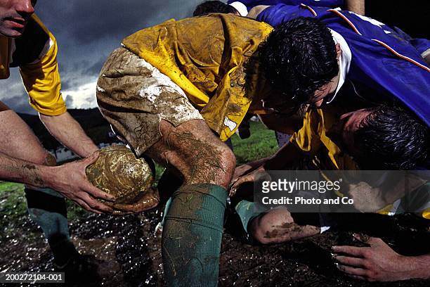 rugby player passing ball through legs at ruck, close-up - ruck stock-fotos und bilder