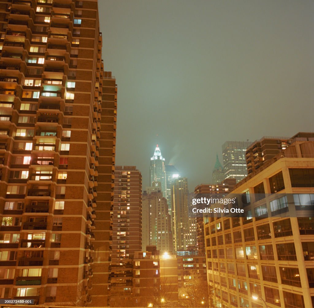 Apartment buildings and city skyline, night