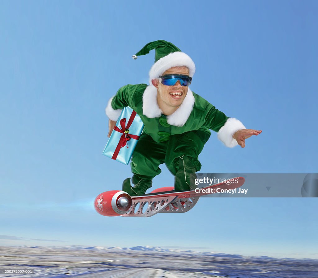 'Elf' flying on 'jet board', holding present (digital composite)