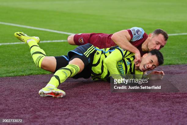 Gabriel Martinelli of Arsenal is challenged by Vladimir Coufal of West Ham United during the Premier League match between West Ham United and Arsenal...