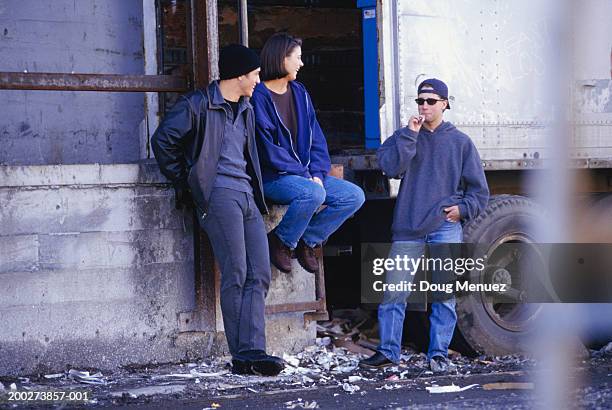 teenagers (16-17) smoking beside derelict building - smoking weed stock pictures, royalty-free photos & images