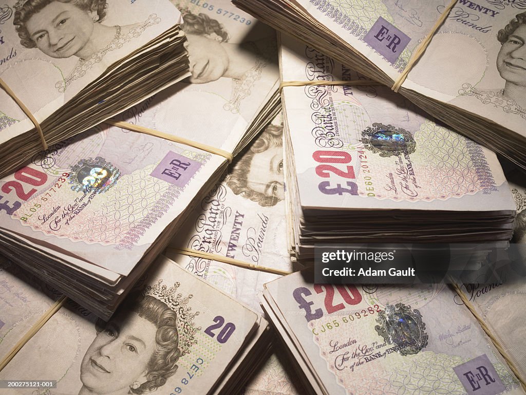 British Currency: Wads of twenty pound banknotes in pile, close-up