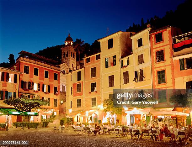 italy, genoa, portofino, restaurant in piazza, dusk (long exposure) - portofino stock pictures, royalty-free photos & images