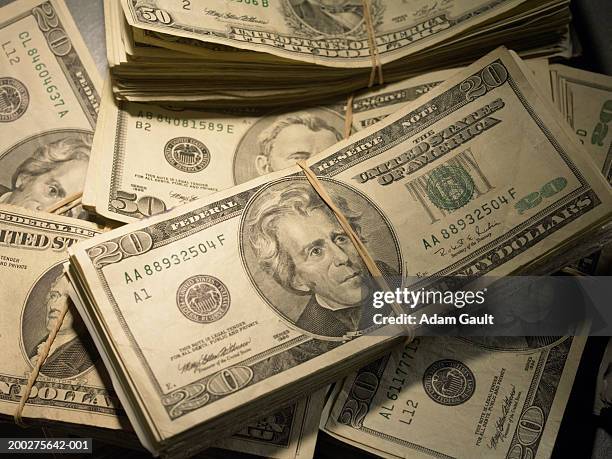 us currency: wads of us bills fastened with rubber bands, close-up - fascio foto e immagini stock