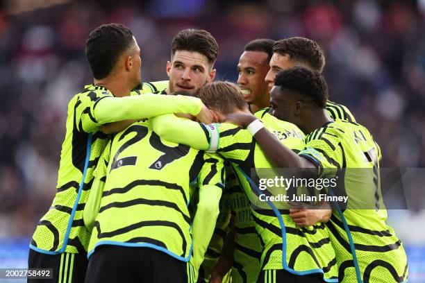 Leandro Trossard of Arsenal celebrates with teammates after scoring his team's fourth goal during the Premier League match between West Ham United...