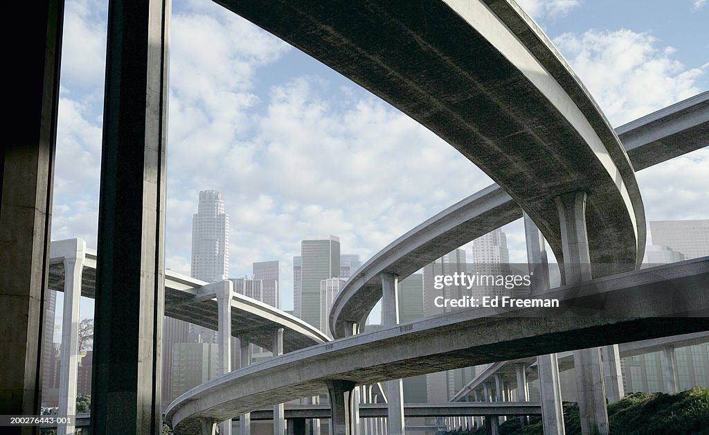 Freeway and office buildings, low angle view (digital composite)