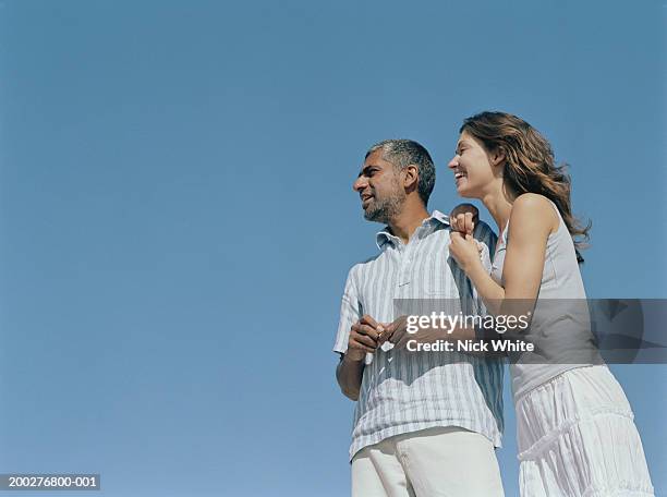 couple outdoors, woman leaning on man's shoulder, low angle view - young woman standing against clear sky stock pictures, royalty-free photos & images