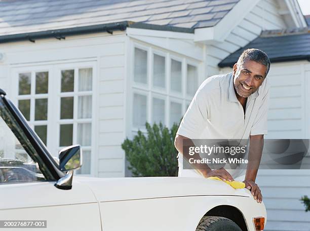 man cleaning car parked outside house, smiling, portrait - indian ethnicity car stock pictures, royalty-free photos & images