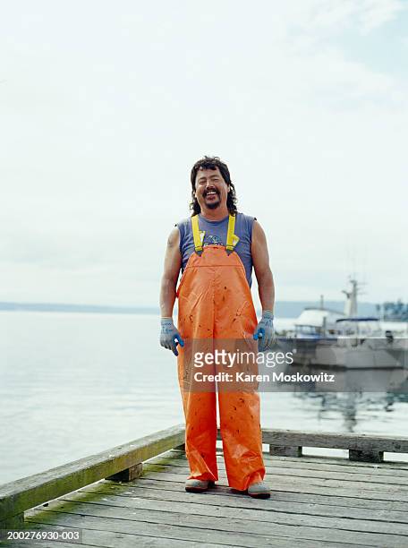 fisherman standing on dock, smiling, portrait - mullet haircut stock pictures, royalty-free photos & images