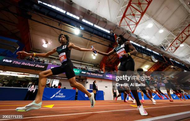 Aidan Peterkin hands off to Isaiah Davis of Elmont High School during the 116th Millrose Games at The Armory Track on February 11, 2024 in New York...