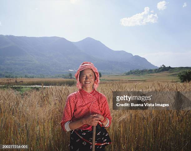 nepal, kathmandu valley, woman standing in field, portrait - nepal women stock pictures, royalty-free photos & images