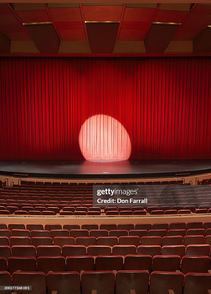 Spotlight shining on stage in empty theater