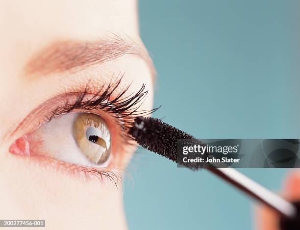 young woman applying mascara, close-up of eye - mascara stock pictures, royalty-free photos & images