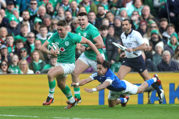 Jack Crowley of Ireland evades the tackle attempt of Ange Capuozzo of Italy, before going on to score his team's first try during the Guinness Six...