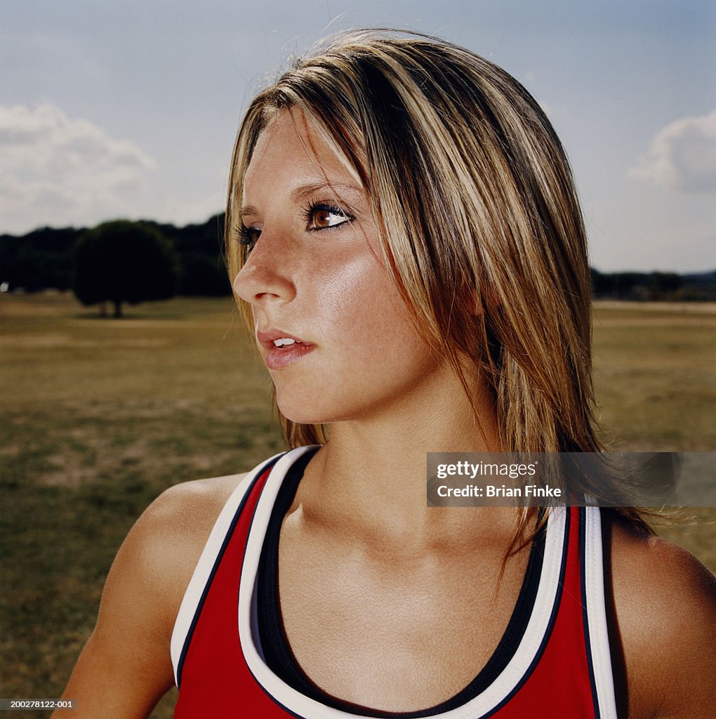 Teenage (16-18) cheerleader looking away, close-up
