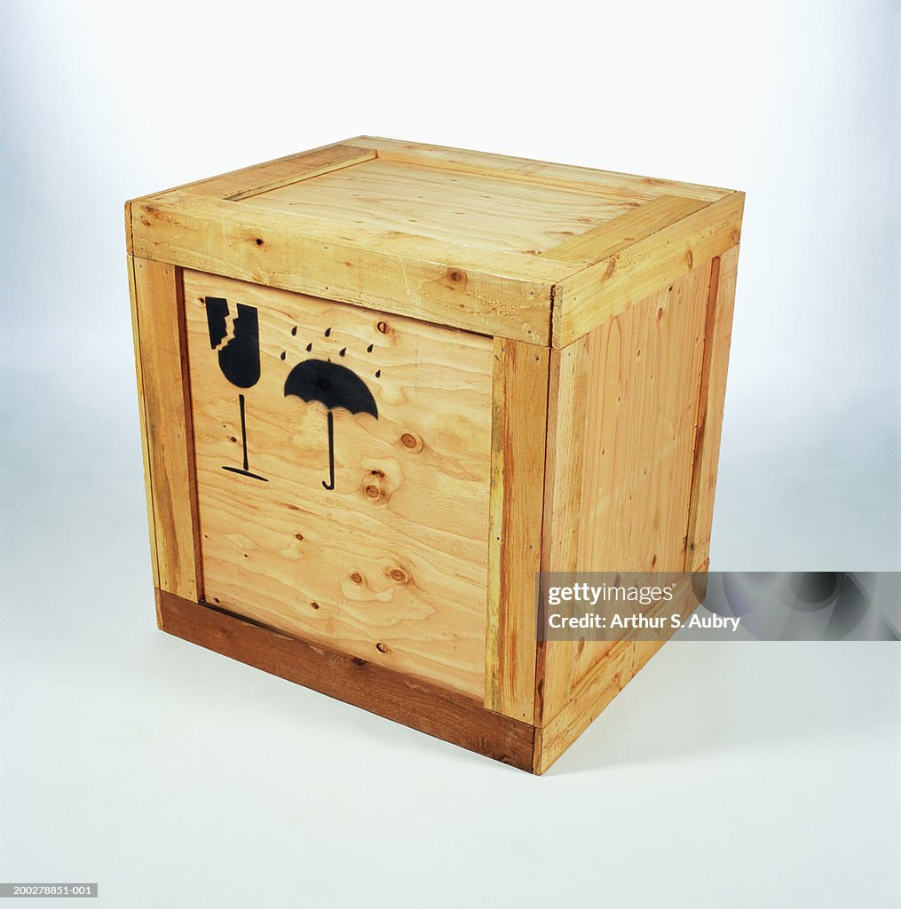 Wooden crate with 'Fragile' and 'Do not get wet' symbols