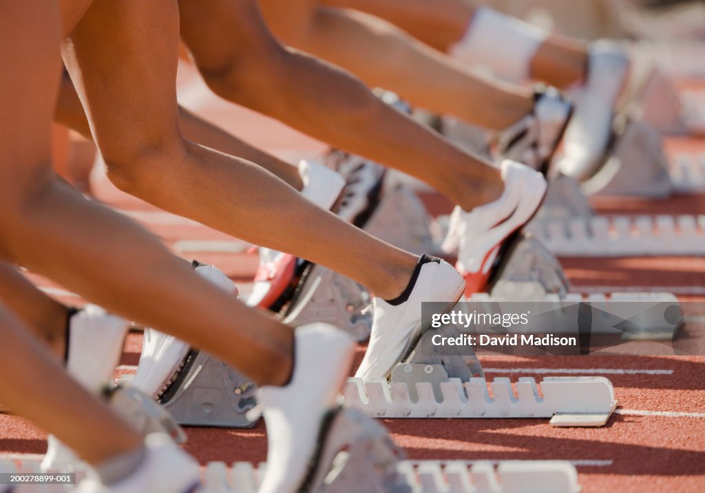 Runners with feet in starting blocks, low section