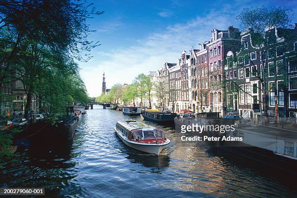holland, amsterdam, sight seeing boat on canal - amsterdam stock pictures, royalty-free photos & images