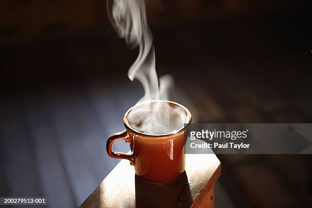cup of steaming coffee - stoom stockfoto's en -beelden