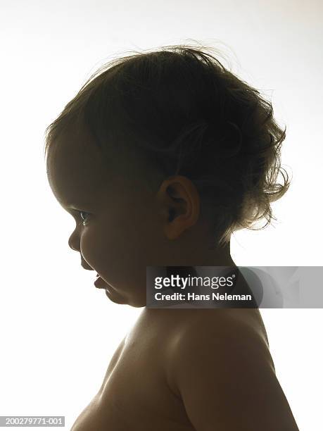 silhouette of baby girl (12-15 months) smiling, side view, close-up - curls girl silhouette ストックフォトと画像