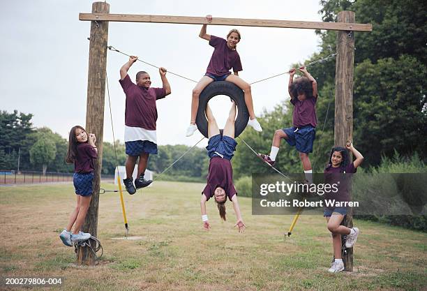 group of children (9-12) playing outdoors, smiling - climbing frame stock pictures, royalty-free photos & images