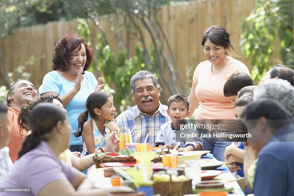 Three generation family sitting at a picnic table