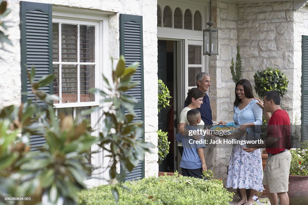 Side profile of a mid adult couple visiting a senior couple