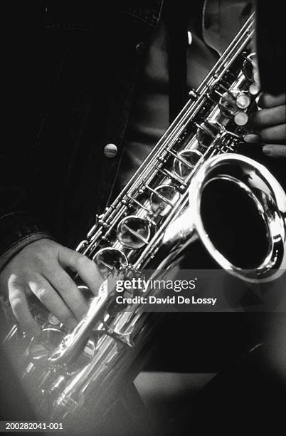 musician playing saxophone, close-up, (b&w) - sax stockfoto's en -beelden