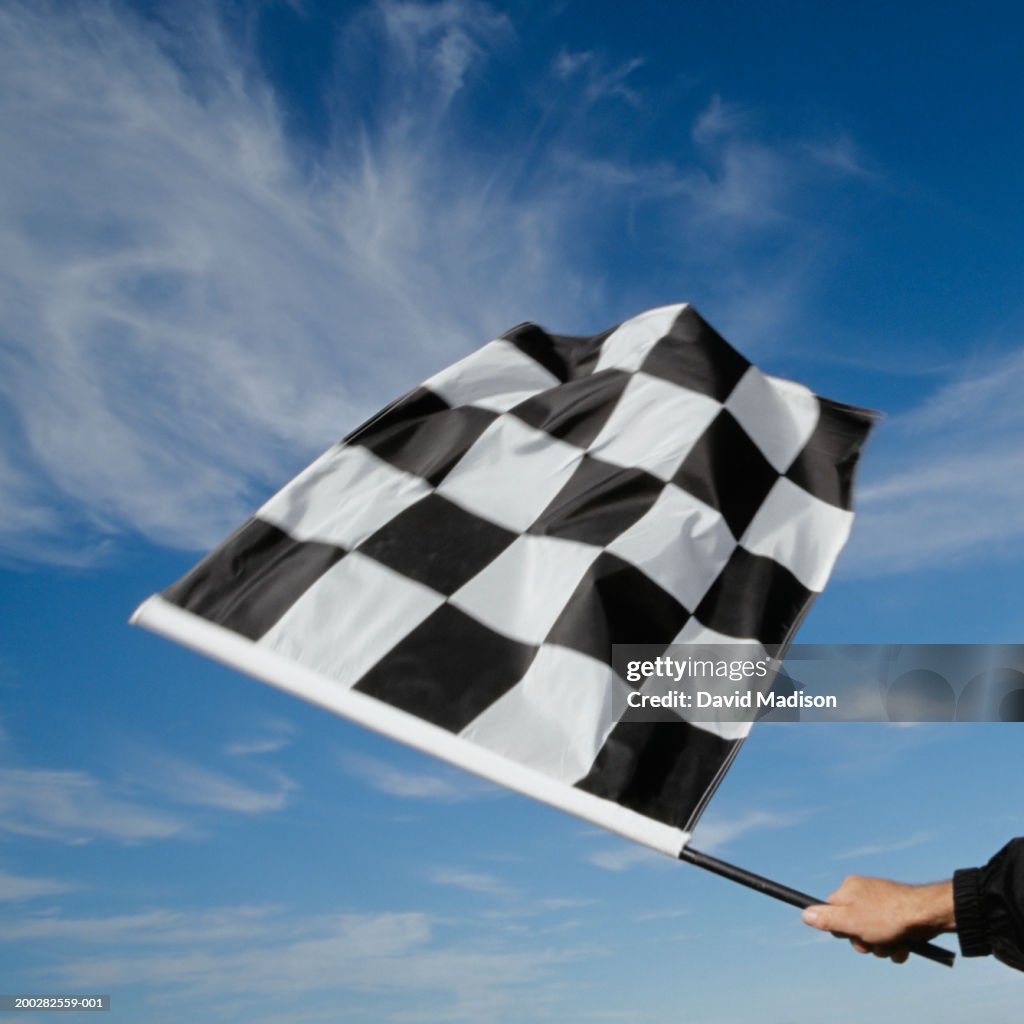 Man waving checkered flag (blurred motion)