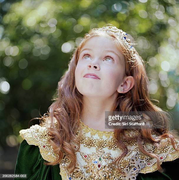 girl (8-10) wearing costume with crown, looking up - kids tiara stock pictures, royalty-free photos & images