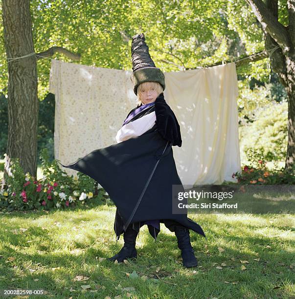 boy (7-9) wearing wizard costume with cape - kid wizard stock pictures, royalty-free photos & images