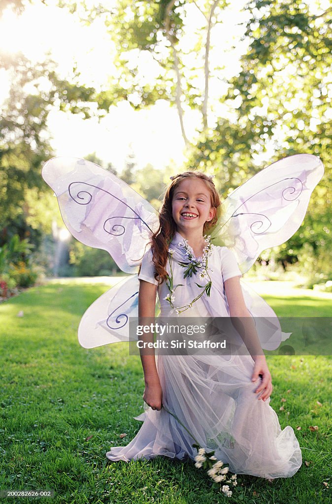 Girl (8-10) wearing costume with wings