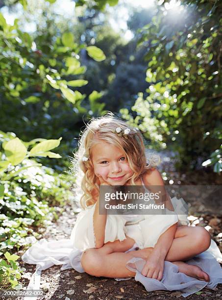 girl (4-6) in white dress sitting on ground, portrait - barefoot child stock pictures, royalty-free photos & images