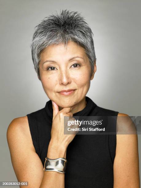 mature woman wearing black top, portrait - mature women portrait asian stock-fotos und bilder