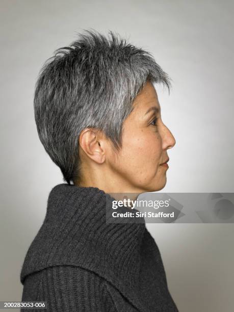 mature woman wearing grey top, profile - side profile stock pictures, royalty-free photos & images