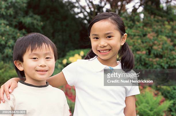 brother and sister (4-6) outdoors, smiling, close-up, portrait - vietnamese ethnicity stock pictures, royalty-free photos & images