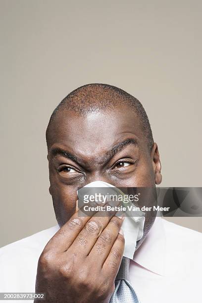 man blowing nose, close-up - blowing nose stock pictures, royalty-free photos & images