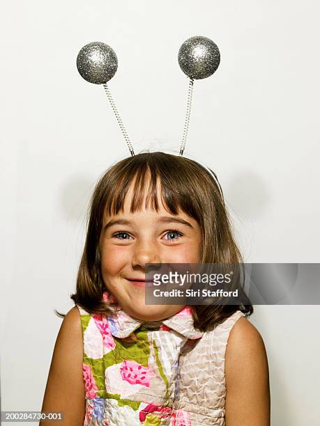 girl (6-8) wearing antenna headband in photo booth - deely bopper stock pictures, royalty-free photos & images