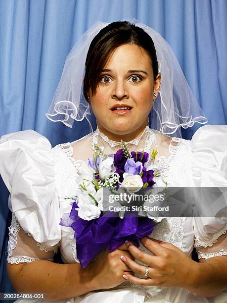 young bride holding bouquet of flowers in photo booth - nervous bride stock pictures, royalty-free photos & images