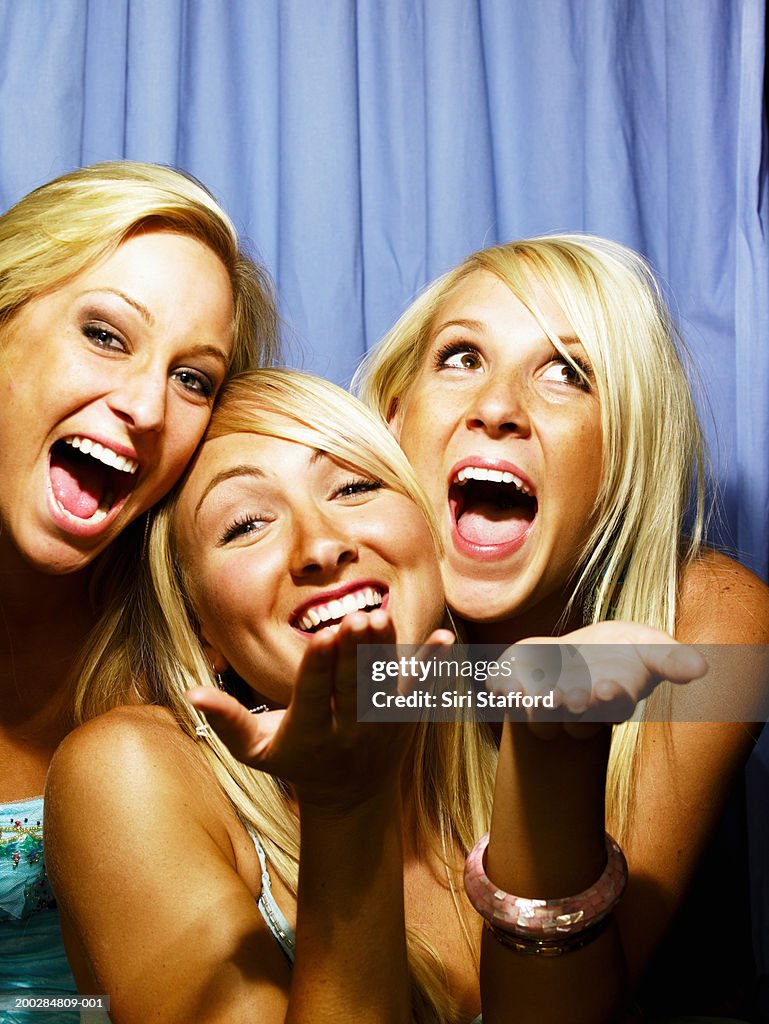 Young women having fun in photo booth